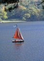 Family in sailing dinghy on lake