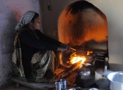 Indian woman cooking over an open fire