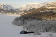 Ice and snow cover the lake at Grasmere